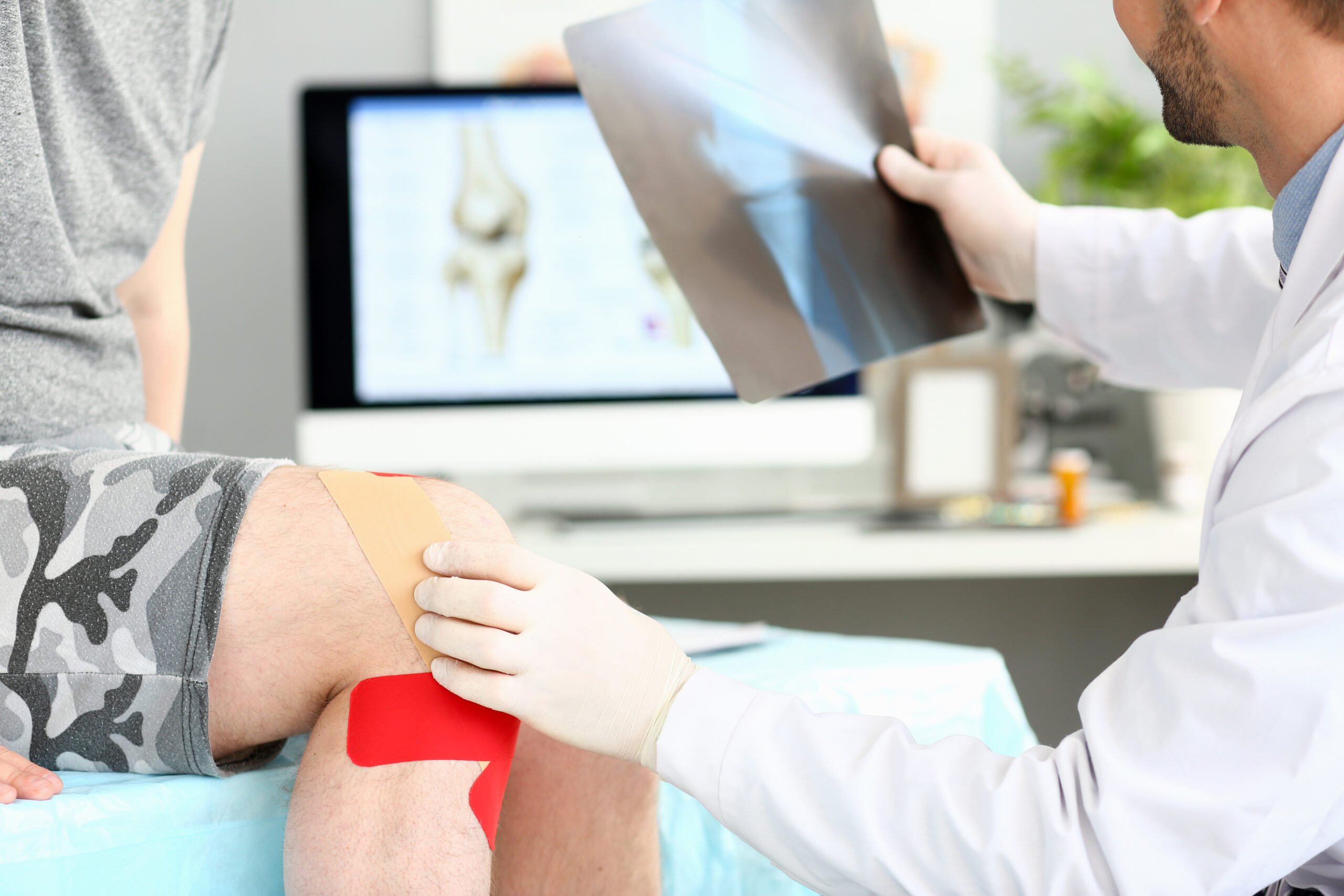 Doctor with patient holding xray shot prescribing treatment poradnia ortopedyczna Zabrze